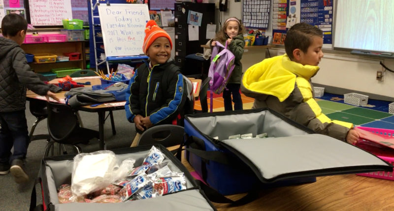 Kids having breakfast in the classroom at Cora Kelly