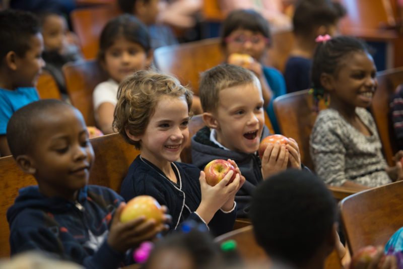 Charles Barrett students eating apples at an assembly for the Crunch Heard 'Round Virginia