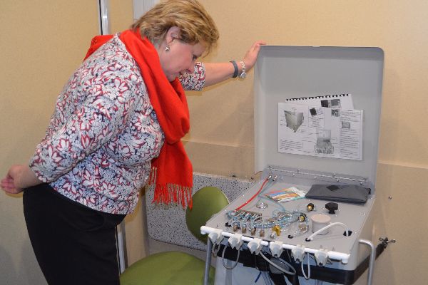 woman looking at dental equipment in WOW bus