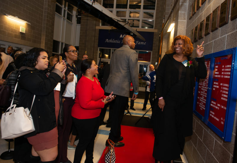 honoree poses with unveiled plaques