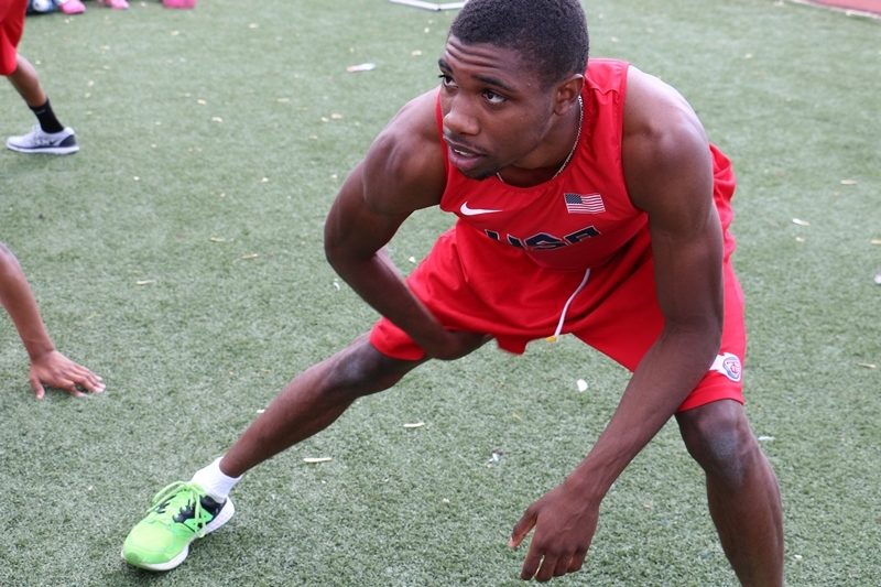 Noah Lyles stretching at practice while attending T.C.