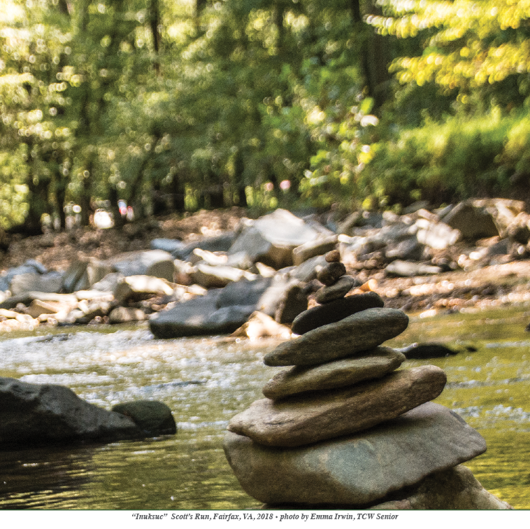 stacked rocks on stream bank