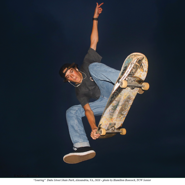 night scene with skateboarded flying overhead