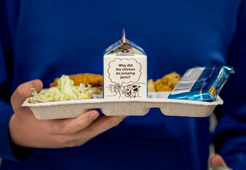 compostable lunch tray with carton of milk. joke on side of carton: why did chicken do jumping jacks?