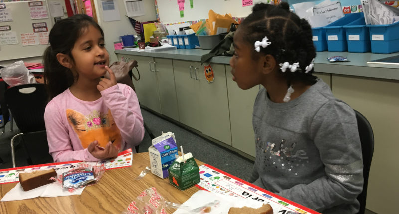 Kids having breakfast in the classroom at Cora Kelly