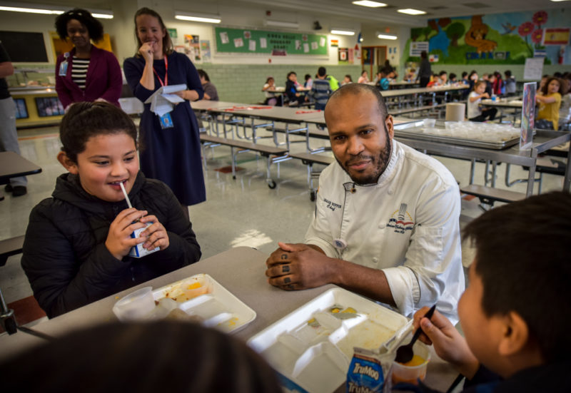 Chef Isaiah Ruffin serves students at Cora Kelly their first taste of vegetarian sausages