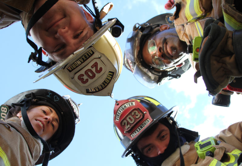 a photo called "Heroes All Around Me." A lot of students sent in photographs of firefighters, but Riley came up with the unique concept of having a circle of firefighters stand around him, looking down at him as he lay on the ground looking up, to take their photo from below