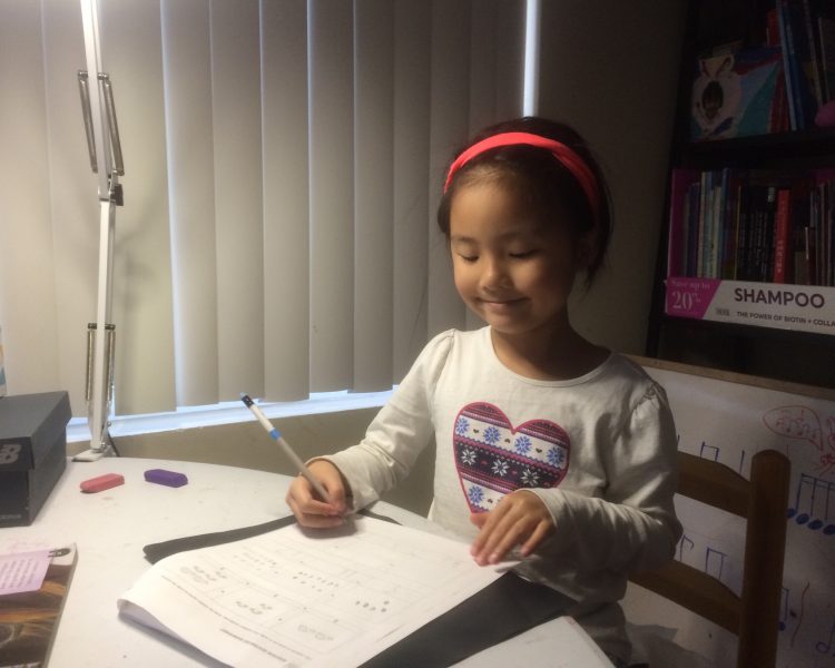 Serena Xiao, 1st grade at MacArthur Elementary School, completing her learning packets.