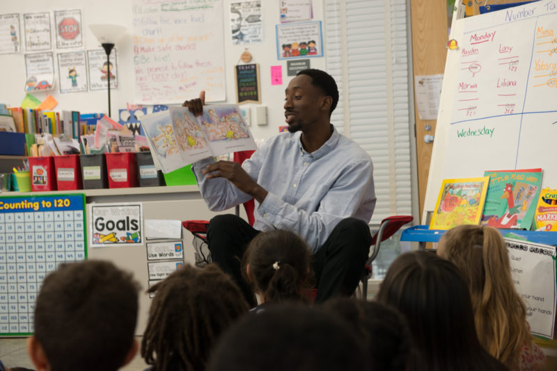 Teacher reading to students in class
