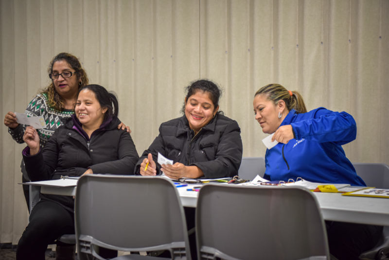 women doing an english exercise together and laughing