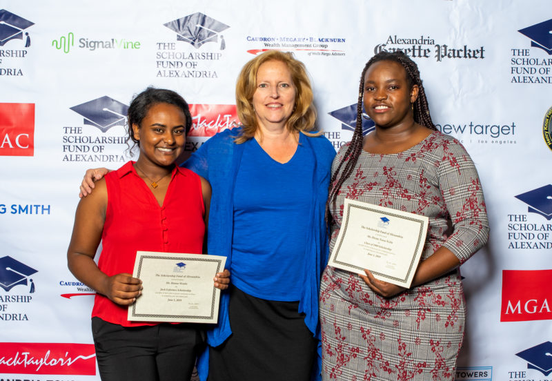 Cindy Anderson, Alexandria School Board Chair presents scholarships to Hannah Woube (L),recipient of the Jack Esformes Scholarship and student keynote speaker Divine Tsasa Nzita (R), recipient of the Class of 1989 Scholarship. Tsasa Nzita will attend Northern Virginia Community College and Woube will attend Virginia Tech.