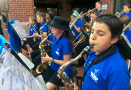 student musicians perform outside before school board meeting