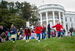 children roll Easter eggs on the White House lawn