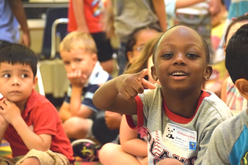 Elementary school student pointing at camera