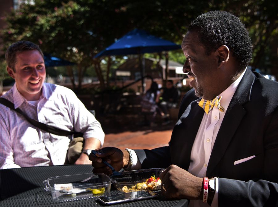 Two male ACPS employees enjoying lunch outside