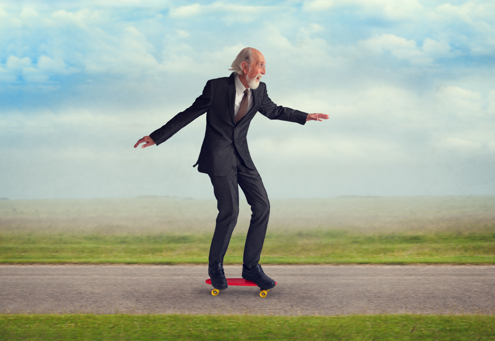 senior man riding a skateboard