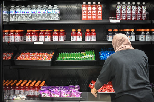 A school nutrition worker puts out food items