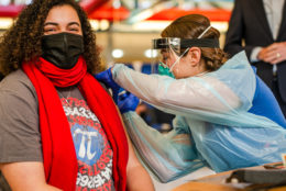 Math teacher Danielle Thorne receives a COVID-19 vaccination shot from a school nurse