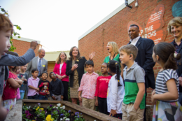 Students and VA First Lady harvest sweet potatoes in school gardent