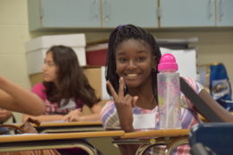 Francis C. Hammond student in classroom giving peace sign