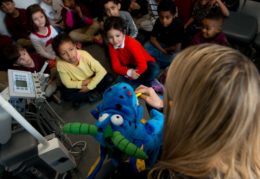 kindergarteners getting lesson in brushing teeth with puppet