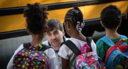 Teacher greeting students on first day of school