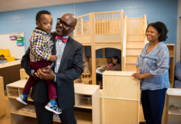 Dr. Hutchings holding pre-school student on day one