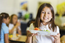 Female student holding lunch tray