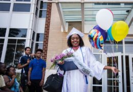 graduate with balloons