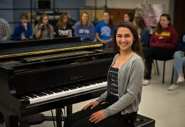 Anya Faruki sits at the piano in her music classroom.