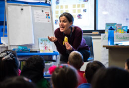 Deborah Haiman talks to her kindergarten class about the characteristics of a banana