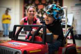 A Barrett student getting to know his new motorized car