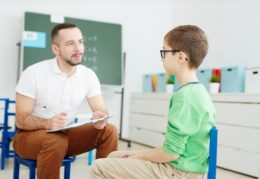 Teacher and student seated facing each other