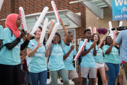 high school students cheering new students on the first day of school