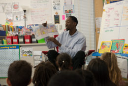 Teacher reading to students in class
