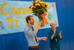 Jesse Mazur walking into a surprise where it was announced that he has been named ACPS Principal of the Year