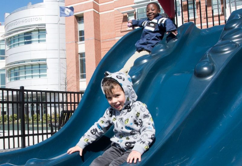 two boys on a slide at Jefferson-Houston playground