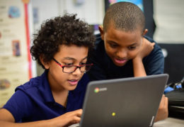 two boys at a computer