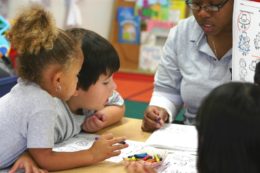 Teacher helping students