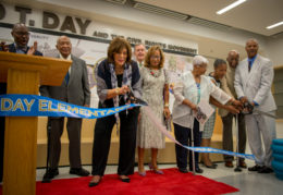 Gwen Day-Fuller cuts the ribbon along with her family