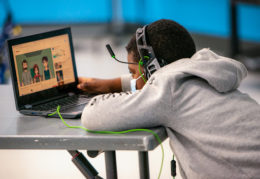 An elementary school boy student learning on a computer screen.