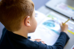 elementary male student working at desk.jpg