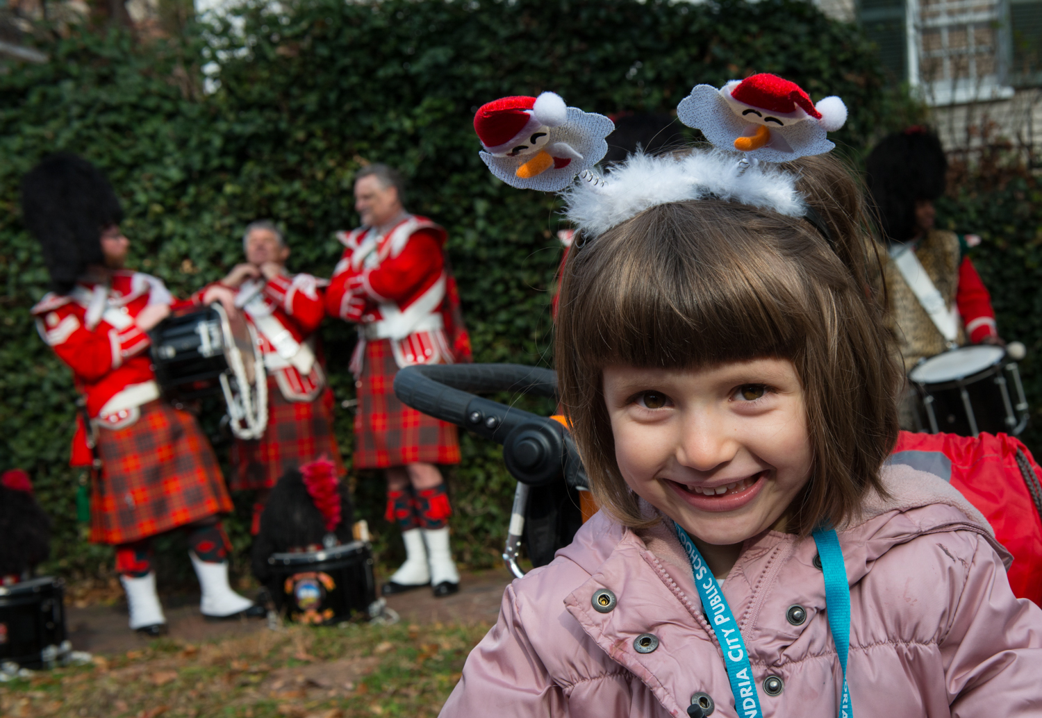 elementary school-age girl with Scottish bagpipe players in the background