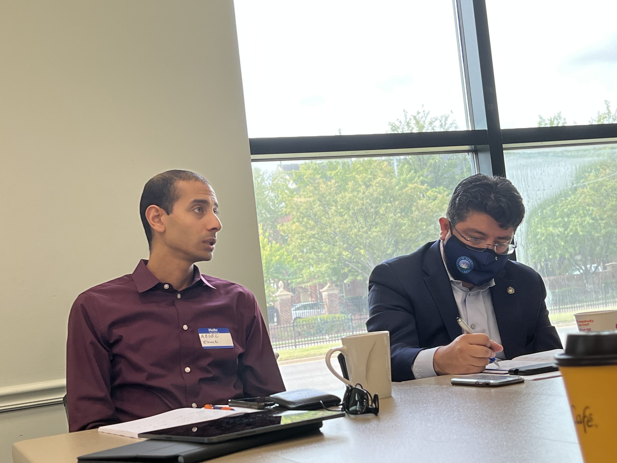 Schoolboard member Abdel Elnoubi, left, speaks at the September 10 listening session. Councilmember Canek Aguirre, right, writes down notes.