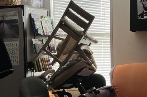 In a classroom, chairs are stacked upon each other to form a barricade in front of a window with drawn blinds during a summer ALICE (Alert, Lockdown, Inform, Counter, Evacuate) drill.